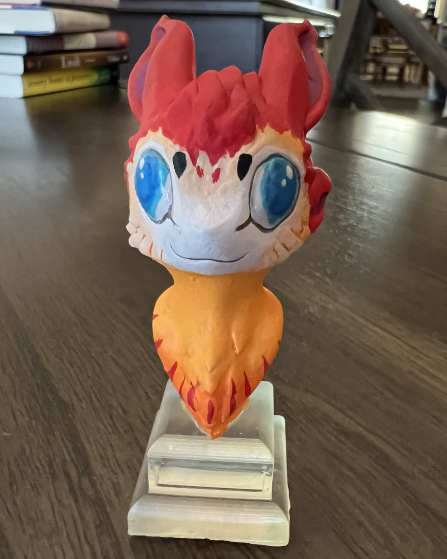 The first official merchandise of the channel! Win your very own miniature bust of Dimitri the Avali, and contribute to charity while you do it!
Standing at 3 inches (7.6 cm) tall, this statue is made from a high-quality, 3d-printed resin base, then professionally hand-painted to match the design we've all grown to love! Vibrant and smiling wide, this little guy fits anywhere you want him, and is sure to brighten up any room you keep him!
In addition to the bust, you'll also be helping the SCHOOL ON WHEELS charity in Southern California. They provide everything from school supplies, to tutoring, to even scholarships, to promote success for children who struggle financially and academically!
50% OF THE AUCTION'S FINAL BID WILL BE DONATED TO SCHOOL ON WHEELS!
The immaculate design and painting work was done by the fabulous peeps over at https://lasercryptid.com/. Check them out on twitter too at @LaserCryptid!